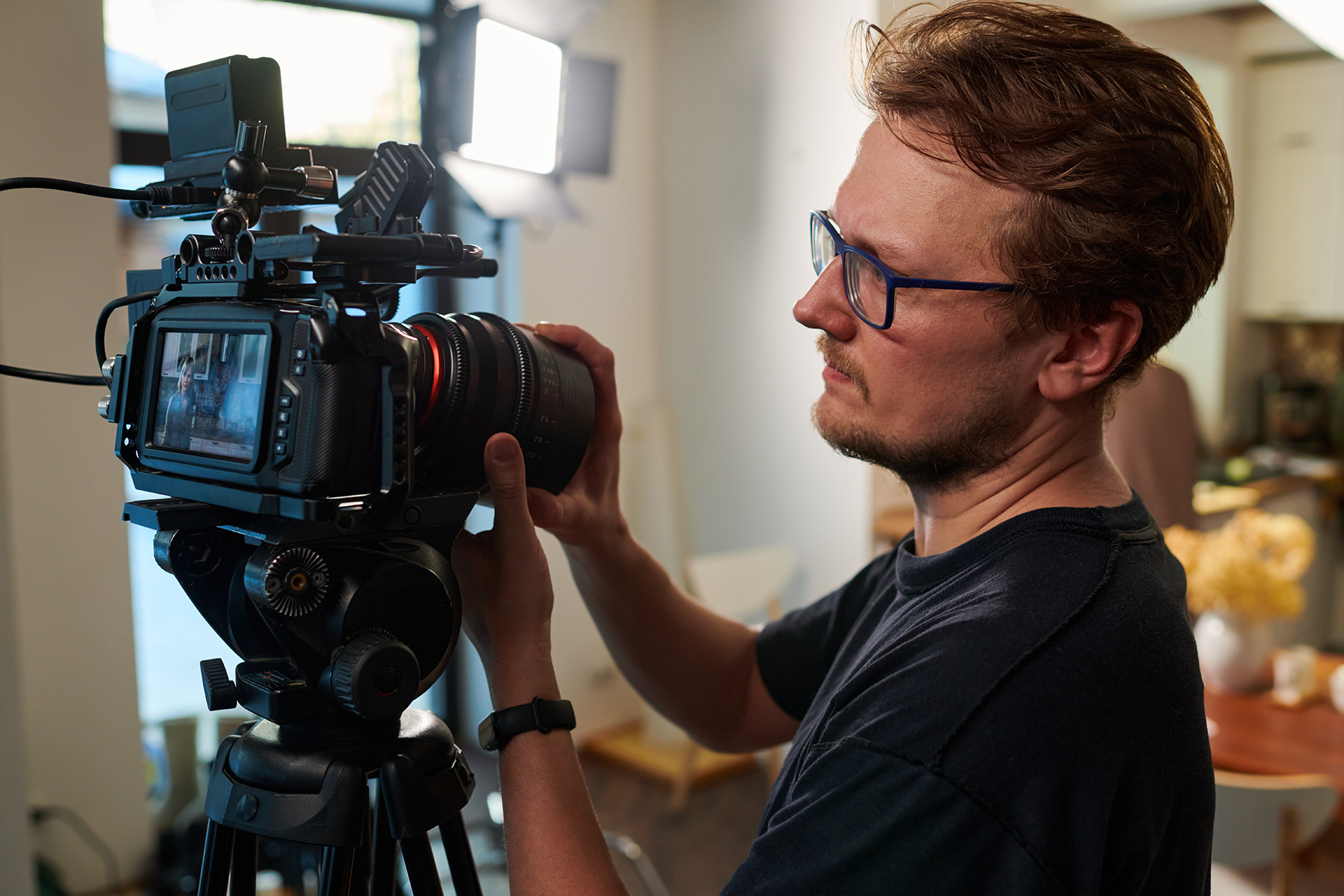 Filmmaker carefully composing an image with a professional video camera