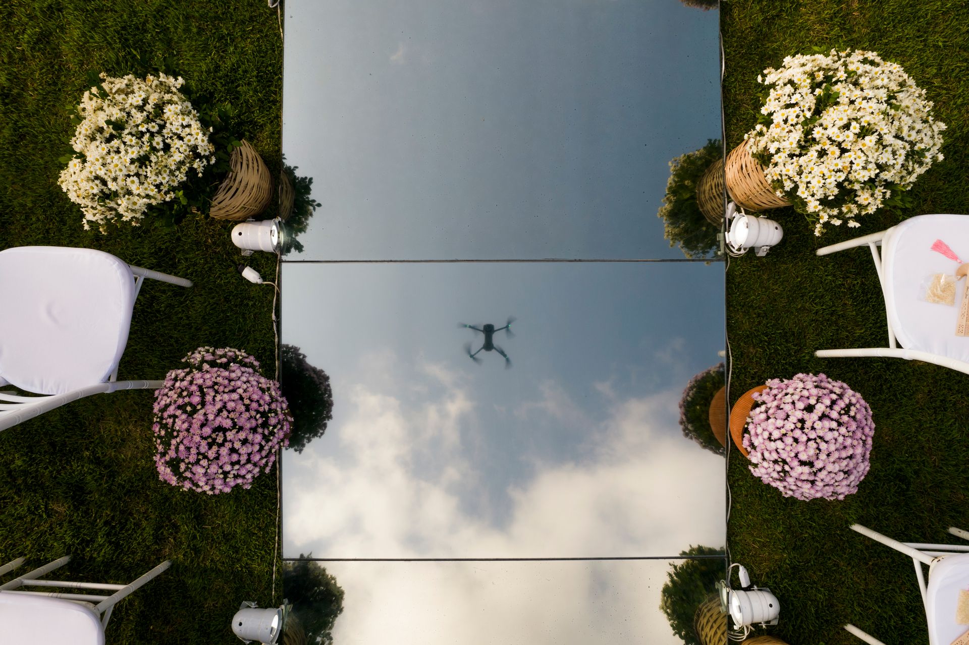 Drone operator preparing aerial camera equipment for wedding videography