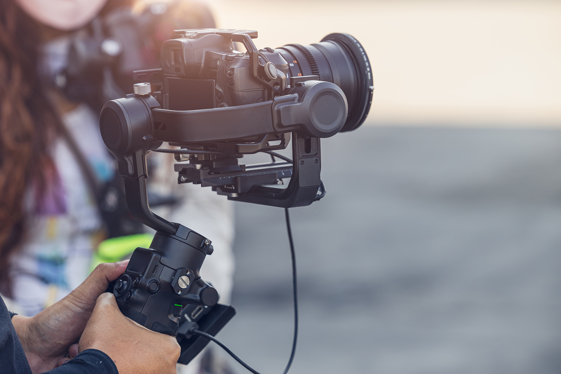 Wedding videographer operating a professional camera on a gimbal